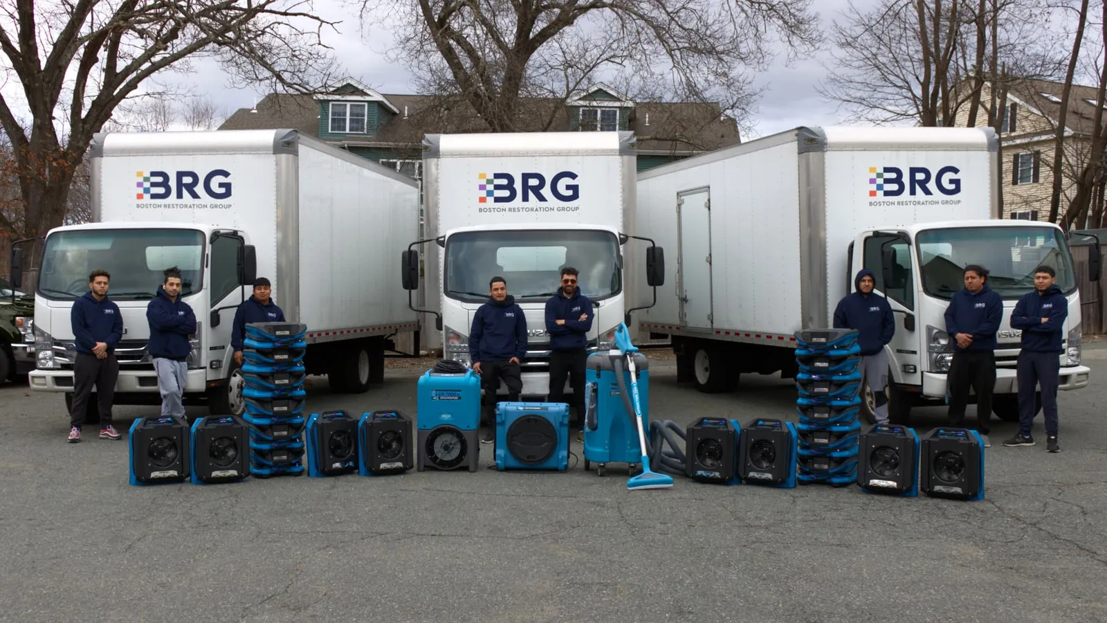 Boston Restoration Group team with branded trucks and professional drying equipment