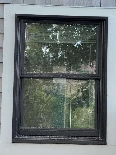 Before photo of dirty windows of a residential home
