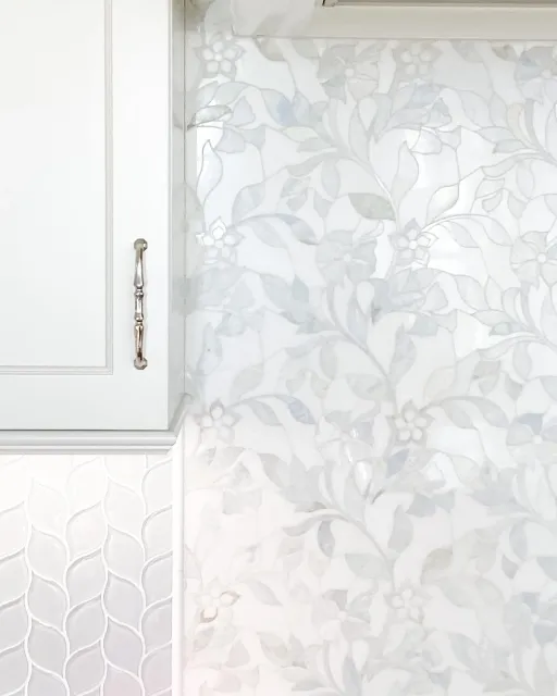 A transitional kitchen remodel in Worcester, MA with custom mosaic backsplash and elegant fixtures.