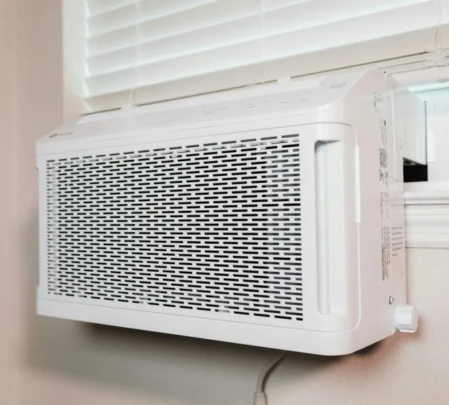 A window air conditioner unit installed in a home window
