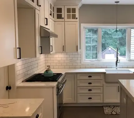 Beautifully remodeled modern kitchen with new cabinets, farmhouse sink, appliances, and granite countertops