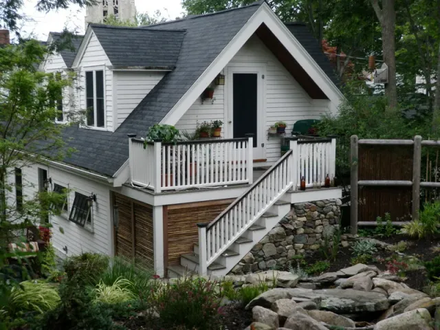 Garage addition. Workshop and garage below, living space above. Garden, pond, and all stonework done by us