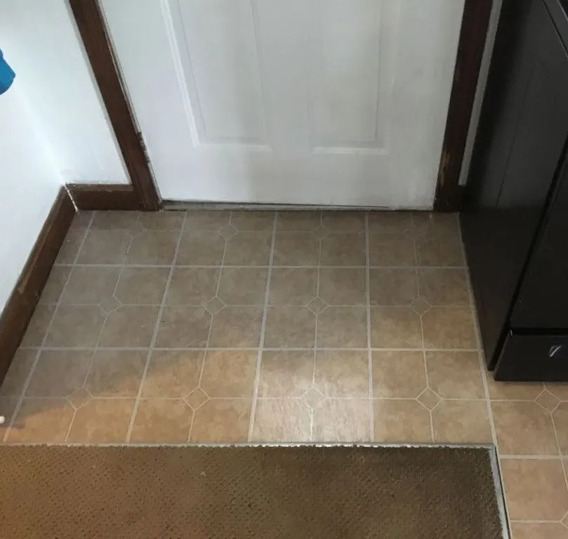Tile floor installation at doorway