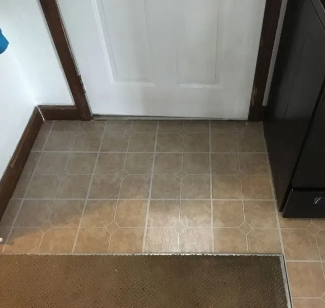 Tile floor installation at doorway