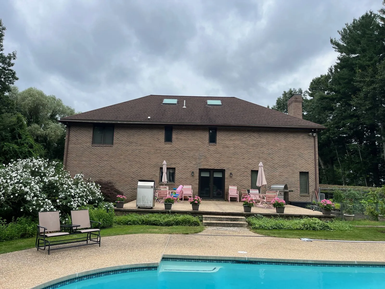 Targeted slate tile replacement and copper flashing repair on a North Shore historic-district home.