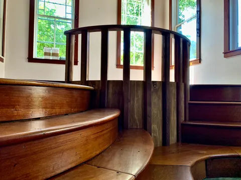 Meditation sunroom built from reclaimed wood with custom railings