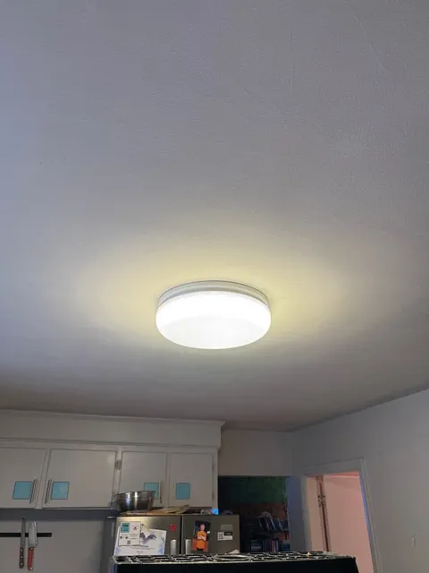 An LED flush-mount fixture replacing a dated kitchen ceiling light.
