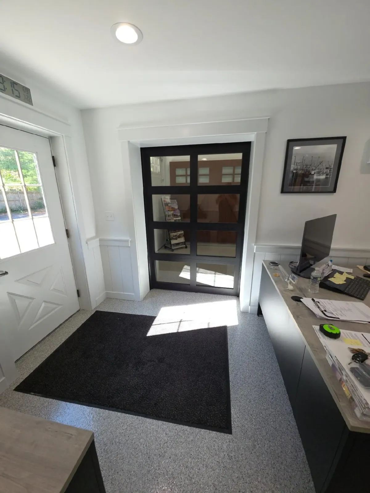 Interior showroom with various garage door styles on display.