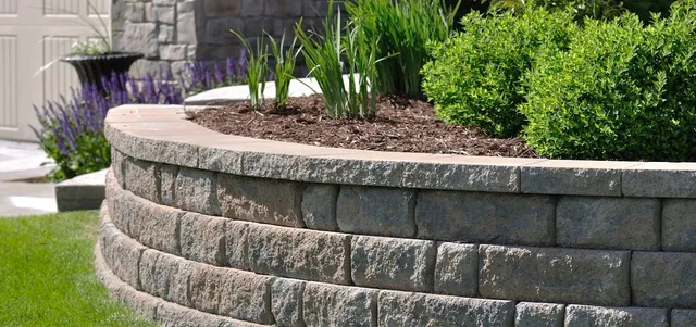 Brick paver retaining wall and planting bed