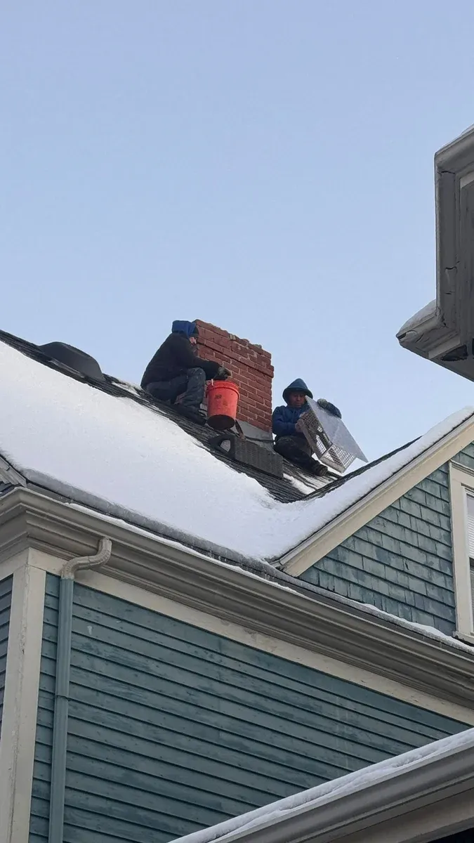 Chimney cap install crew winter roof — Chimney Goat project