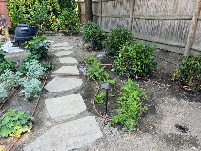 An irrigation system installation in progress at a residential home