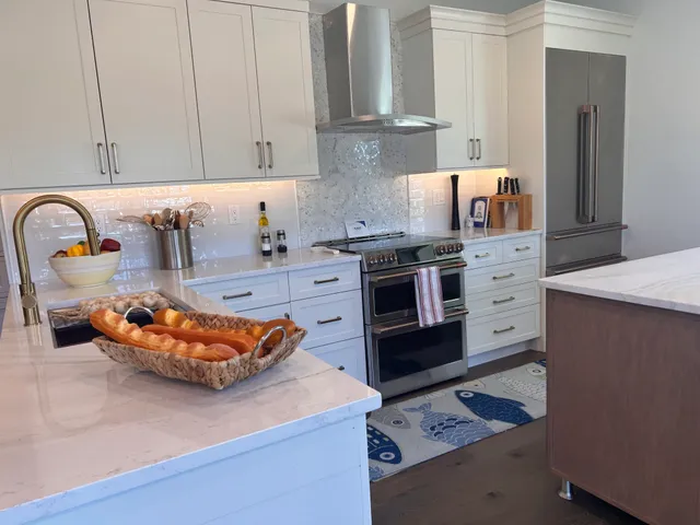 Stainless stove and mosaic tile backsplash