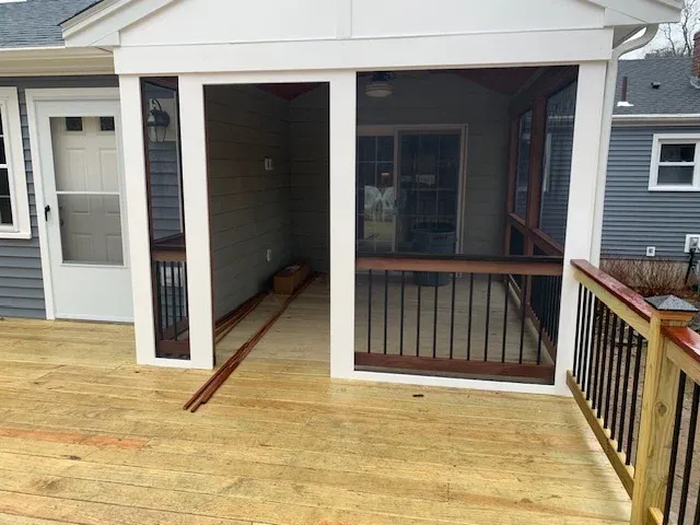 Screened-in porch and deck connection built by SJ Wilson Construction in Hanson, MA.