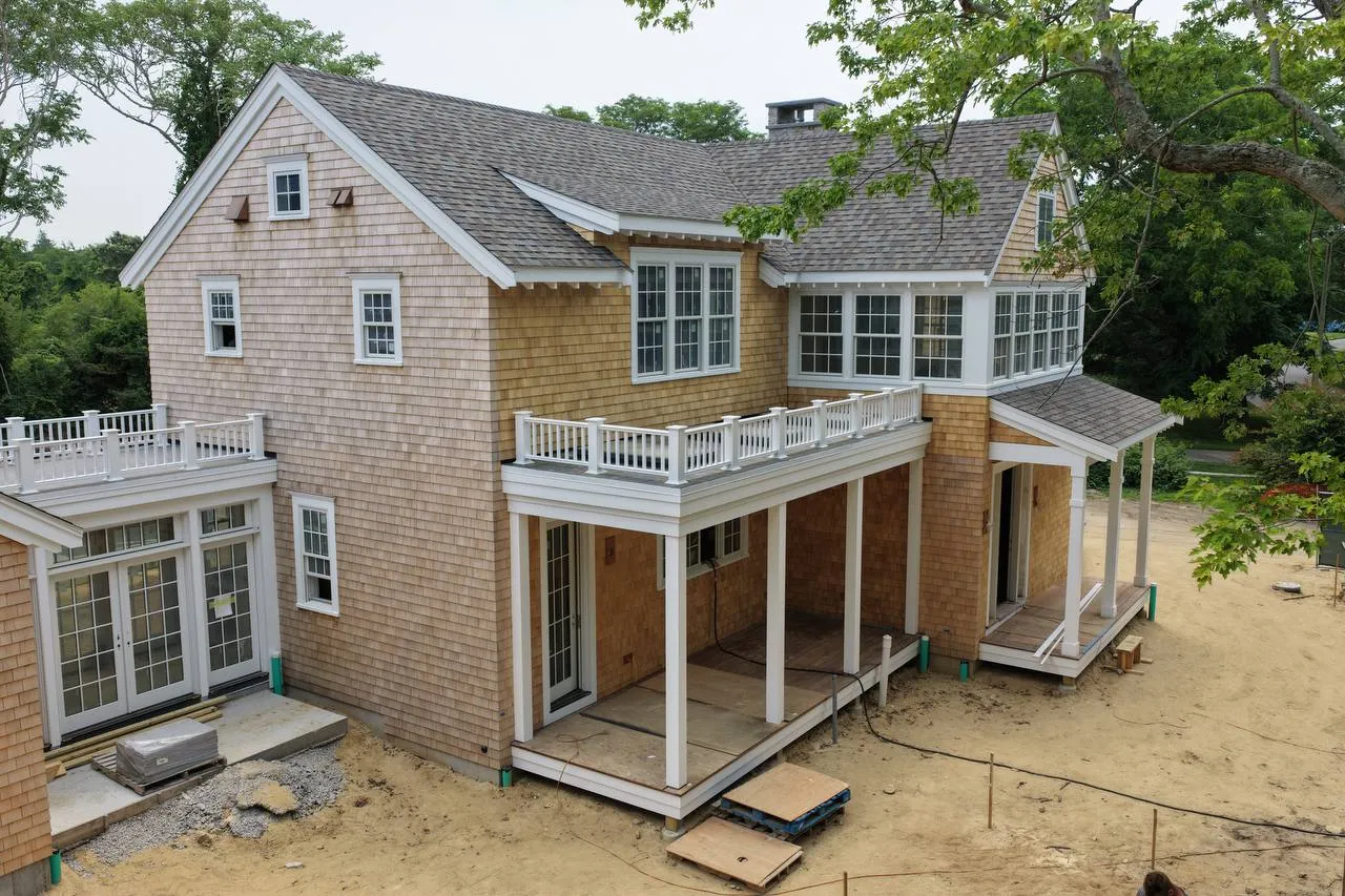 Dennis home exterior with asphalt roof and white cedar sidewall