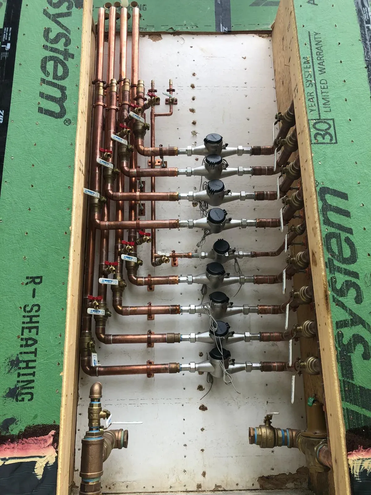 Water manifold system installed by licensed plumbers at RW Plumbing for centralized water flow control in a residential project.