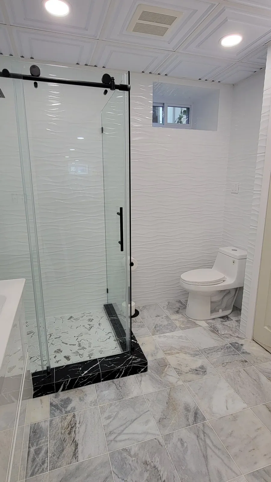 Finished glass shower vanity and tile work in a Marblehead bathroom renovation