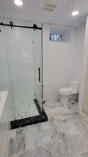Finished glass shower vanity and tile work in a Marblehead bathroom renovation