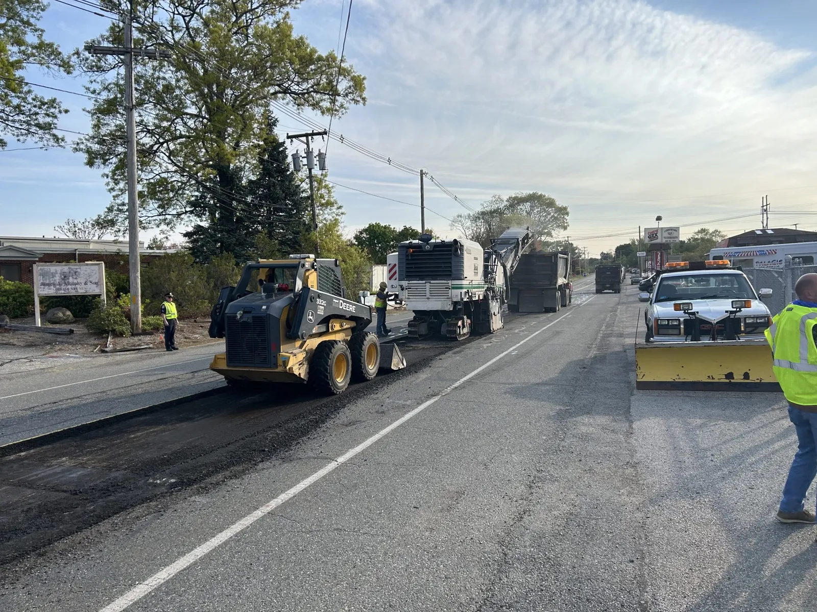 Walsh Contracting Corp performing daytime asphalt milling operations on a roadway in preparation for resurfacing.