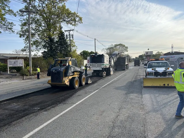 Walsh Contracting Corp performing daytime asphalt milling operations on a roadway in preparation for resurfacing.