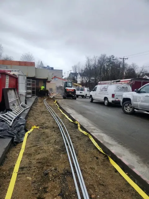 A bunch of trucks are parked on the side of the road.