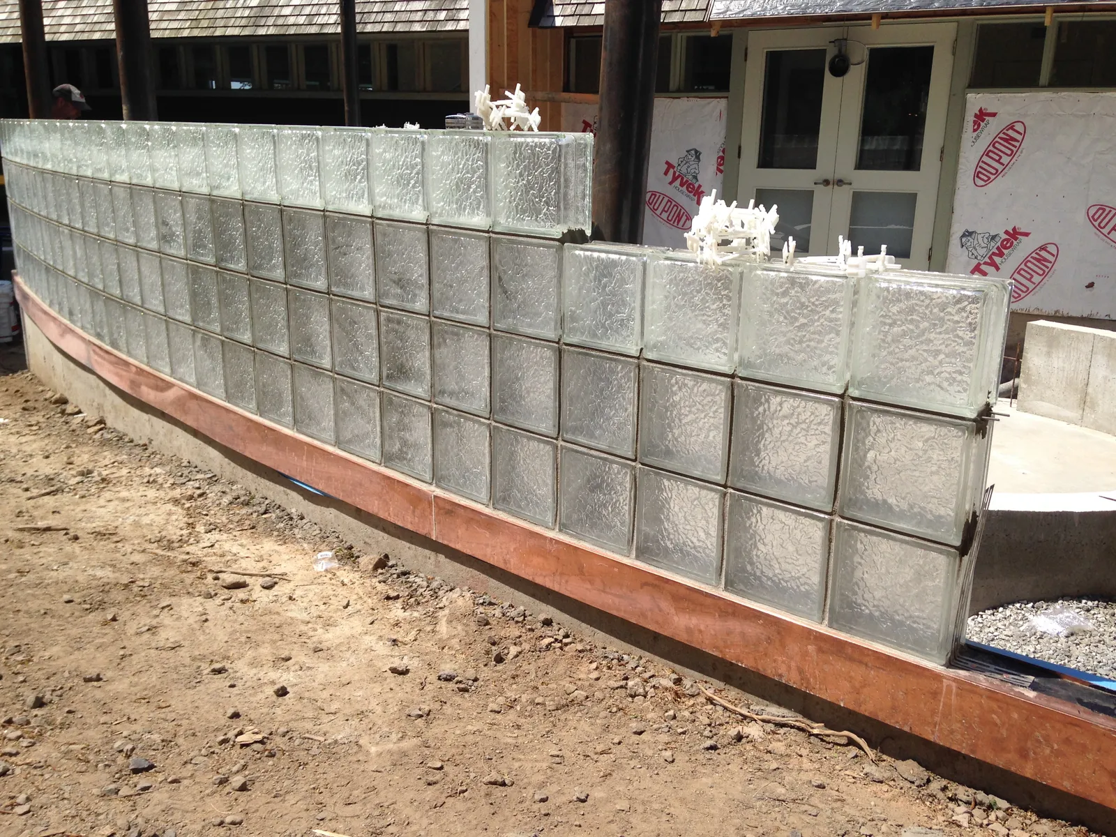 Curved glass block wall with copper base
