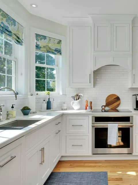 Modern kitchen with white cabinetry, a large island, and cozy seating.