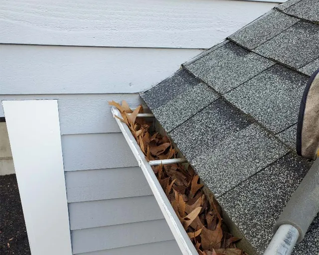 Clogged gutters before being cleaned