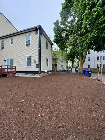 Backyard of house with newly prepared dark brown soil
