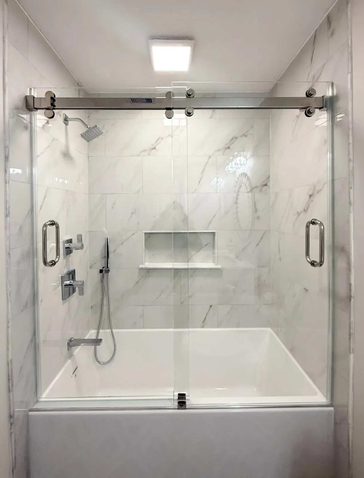 Sliding glass shower door on bathtub