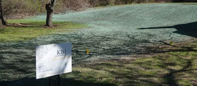 A sign is posted on the side of a road.
