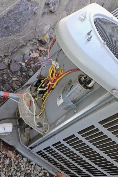 Outdoor air conditioning unit with exposed wiring