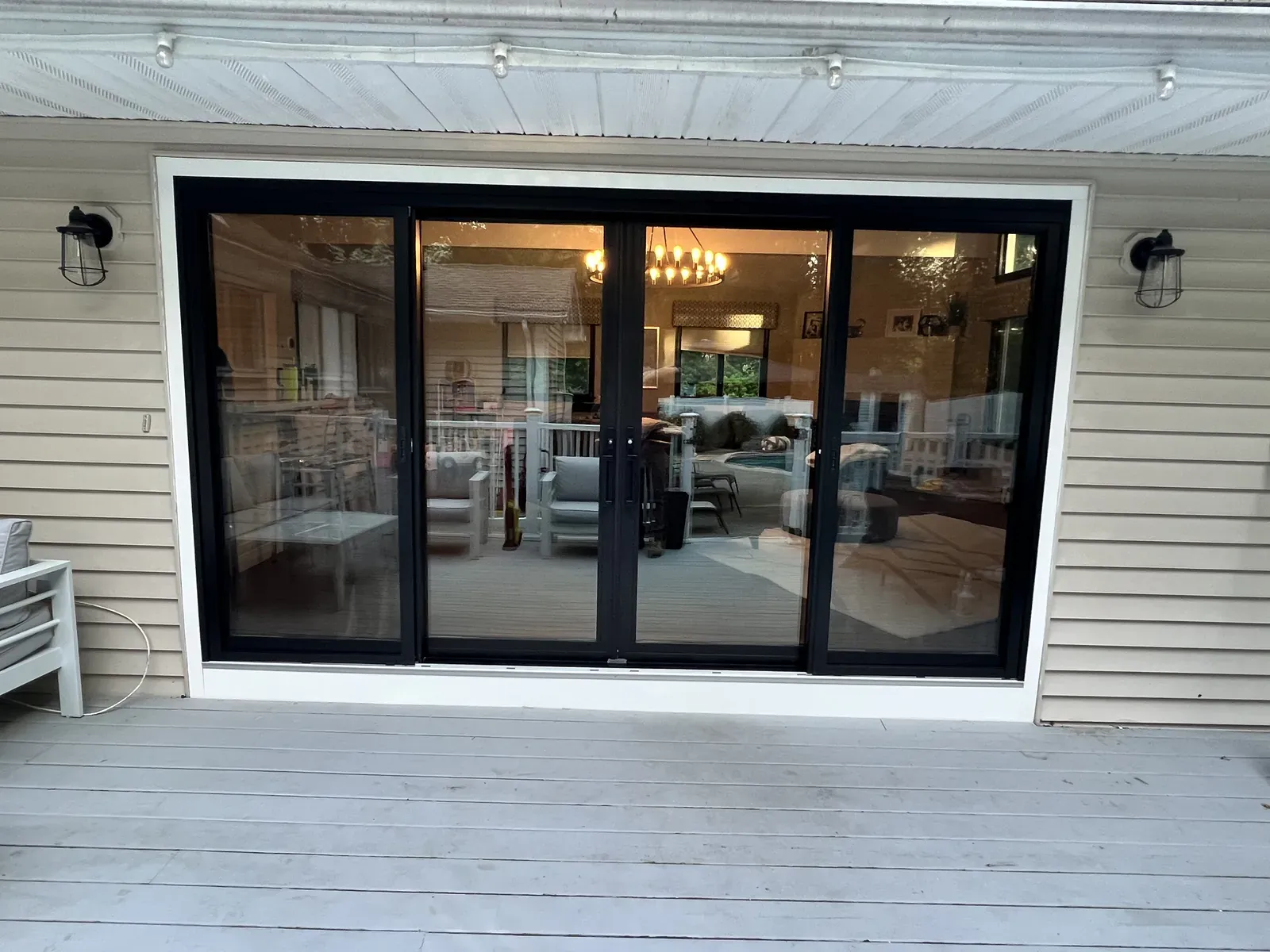 Wide black-framed sliding patio door opening onto a deck