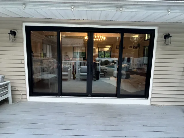 Wide black-framed sliding patio door opening onto a deck