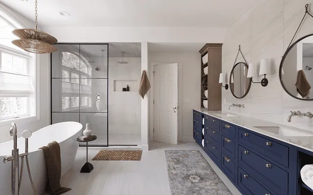 Bathroom Remodel in Burlington Connecticut. Custom double-mirror vanity, soaking tub, curb-less shower, wet room, stone counters