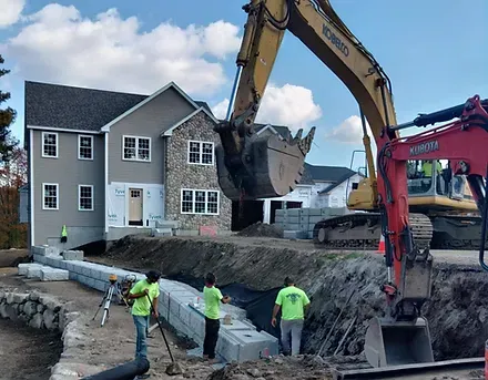 Installation of retaining walls including drainage for a new residential construction in L