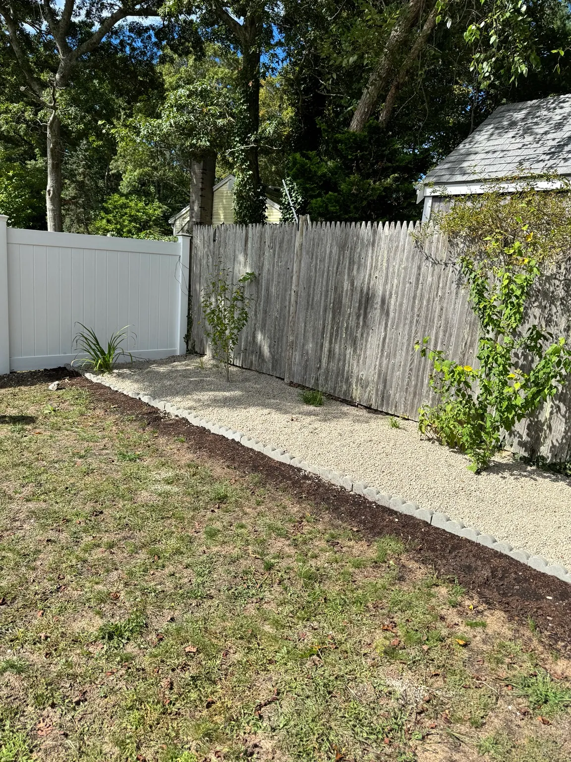 Finished stone landscape bed with a clean curved edge