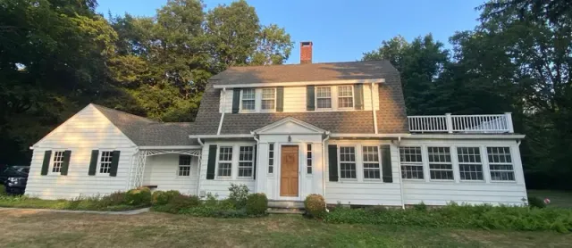 Roof replacement and new gutters on a gambrel-style home in Wilton, CT