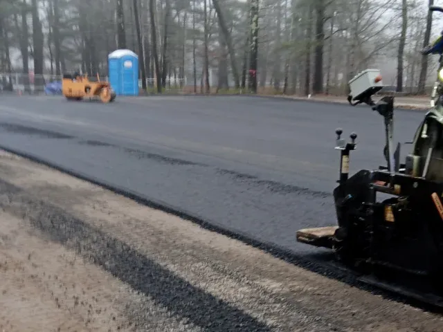 J. A. Cooper laying asphalt for parking lots
