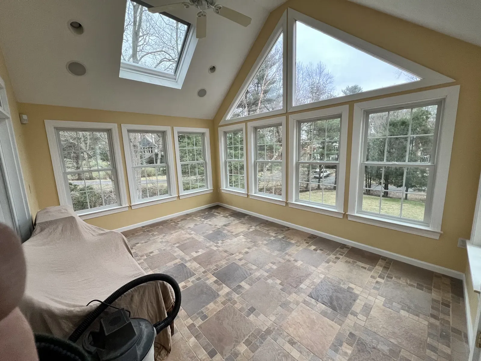 Sunroom addition wrapped in new windows and vaulted ceiling