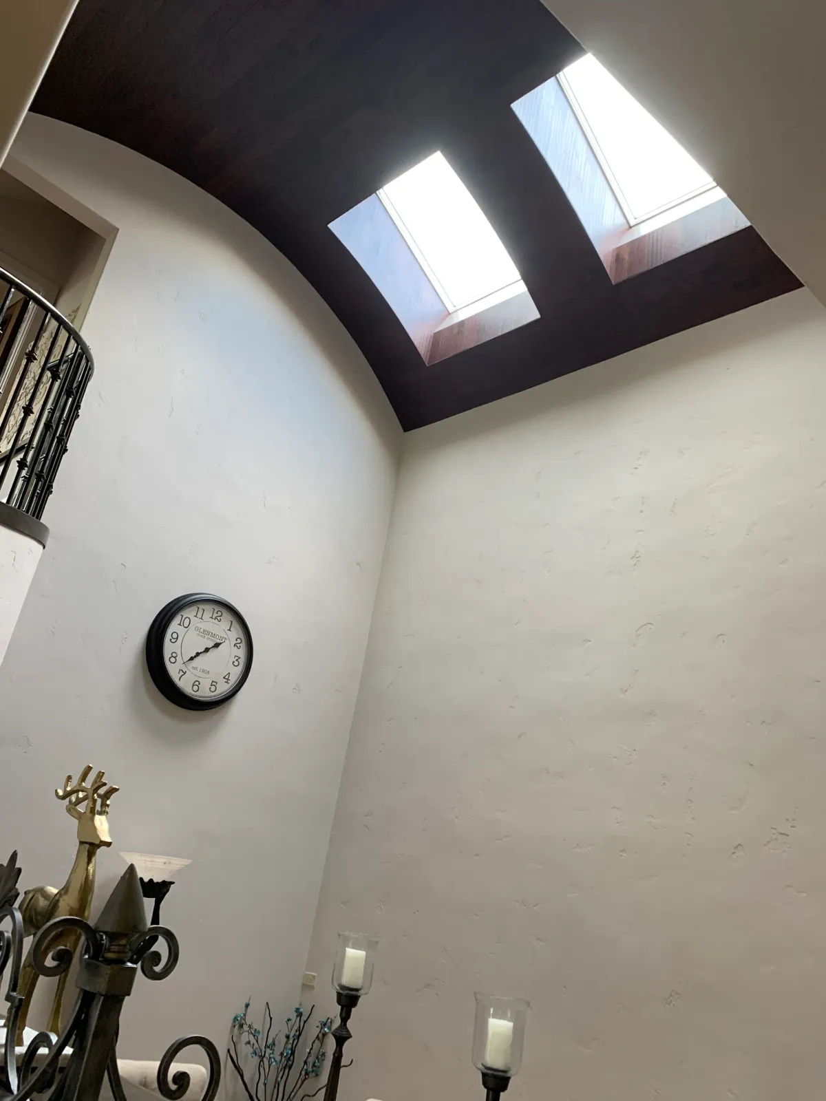 A clock hanging on a wall shows the time as 4:20