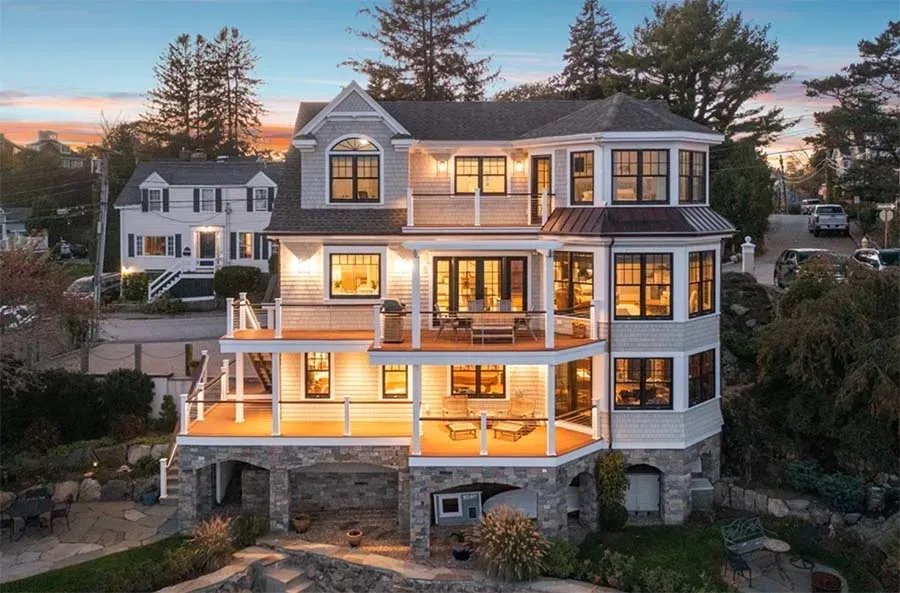beautiful 3 story home lit up at dusk