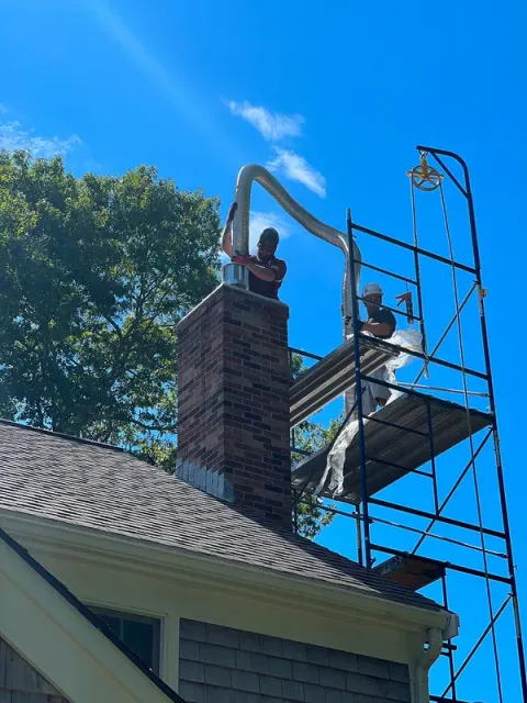 A brick chimney being relined from scaffolding