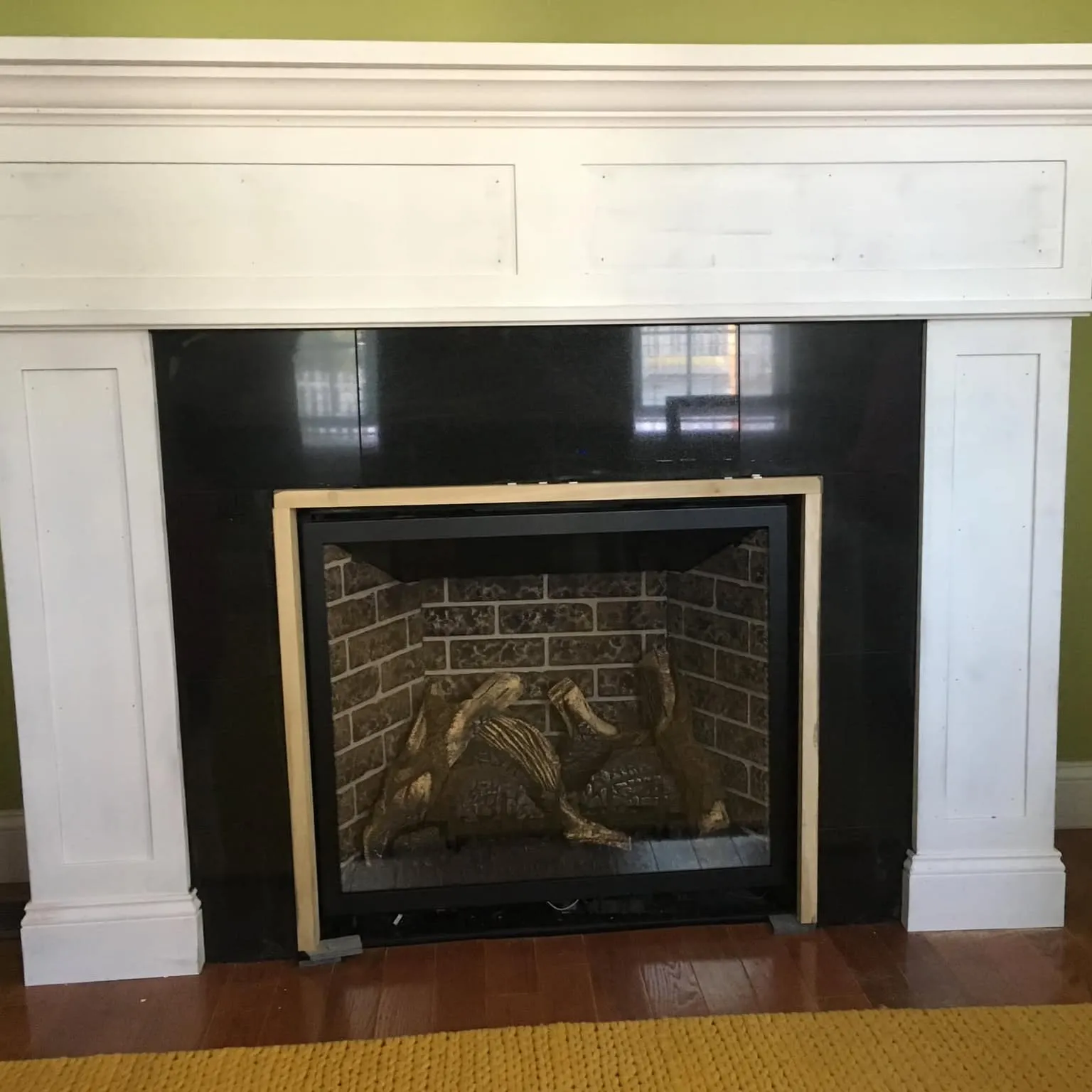 Tiled fireplace surround with mantel