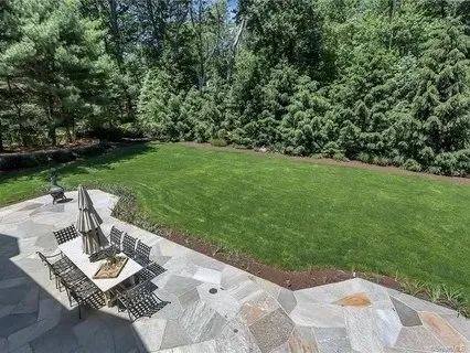 Bluestone patio overlooking a landscaped lawn
