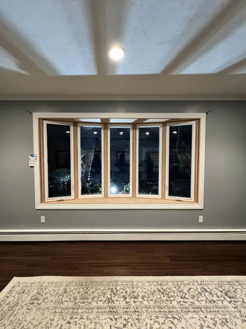 Interior bay window with natural wood casing and trim