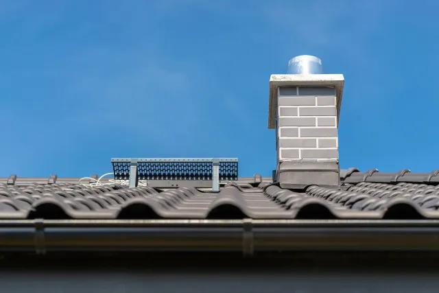 roof-singlefamily-house-covered-with-new-ceramic-tile-anthracite-against-blue-sky-vsible-system-chimney-covered-with-tiles.jpg