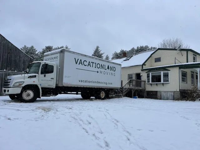 Vacationland Moving Truck in front of a home on a snowy day in Maine