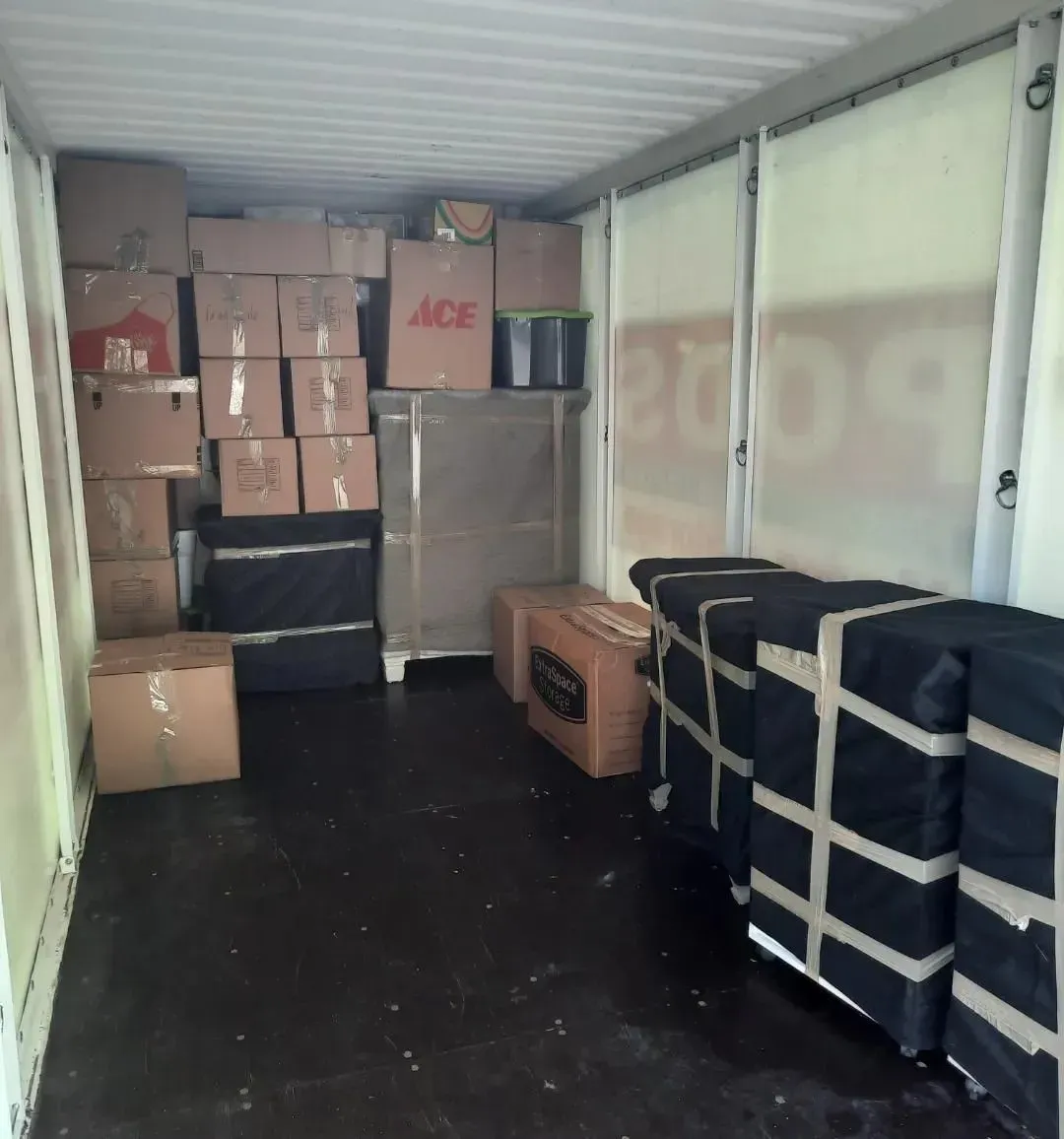 A room filled with boxes and a sign that says ace