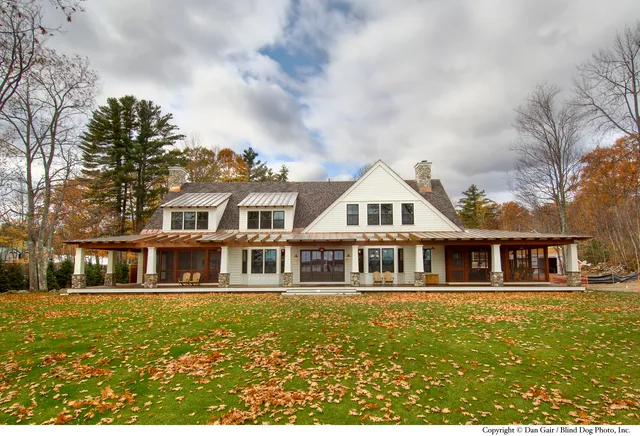 Elegant residential home by Wright-Ryan amidst autumn foliage.