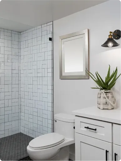 Master bathroom remodel in Stoneham, MA with Carrara marble tile, frameless glass shower and gold fixtures